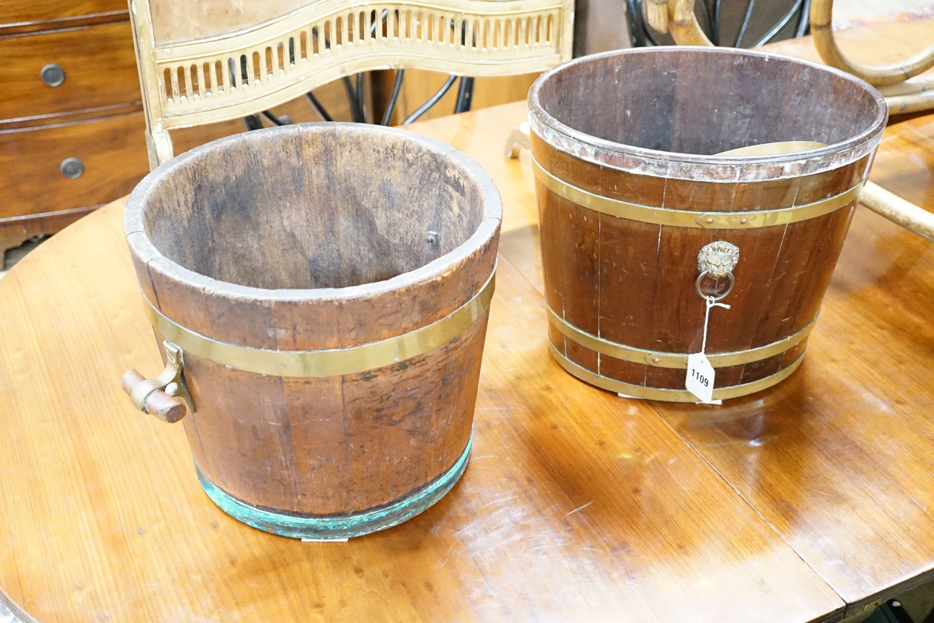 A 19th century brass bound mahogany oval bucket and a similar brass bound oak bucket, width 37cm, height 32cm and width 34cm, height 29cm